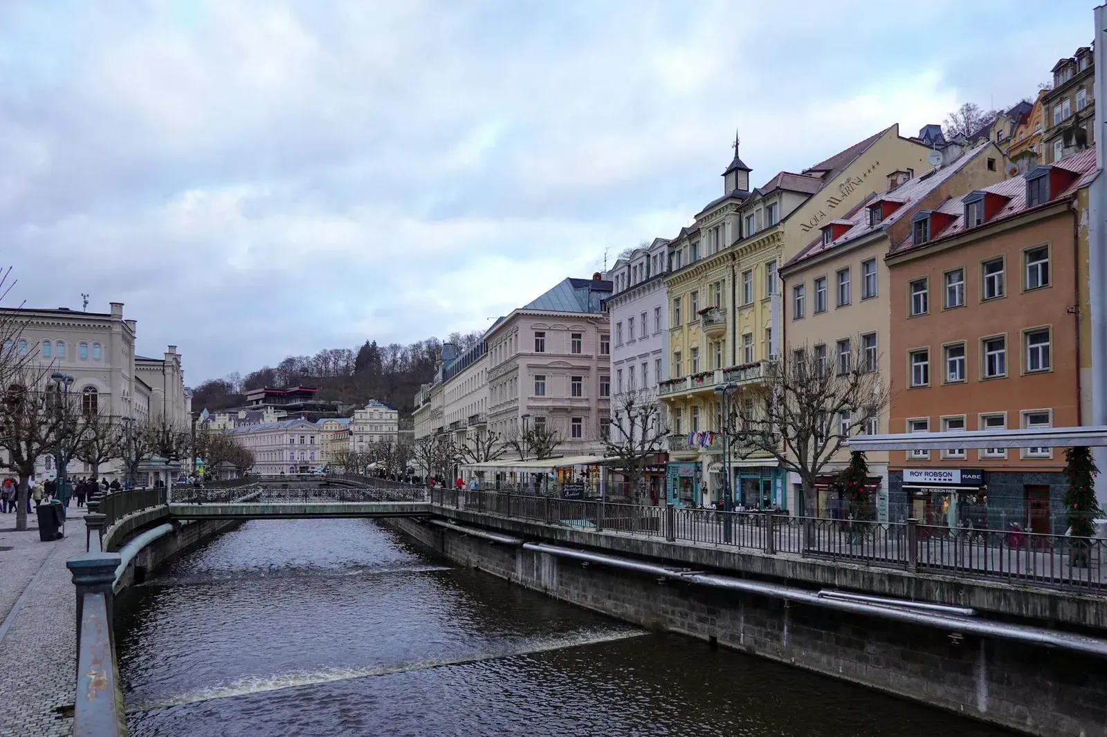 Picturesque view of a river and colorful buildings along the waterfront in Karlovy Vary, Czech Republic.