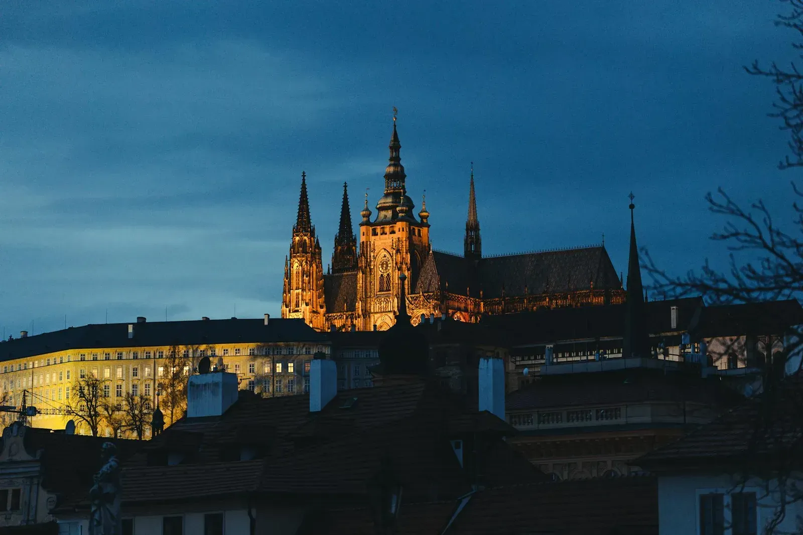 A mesmerizing view of Prague Castle glowing against the evening sky, a must-see landmark in the Czech Republic.