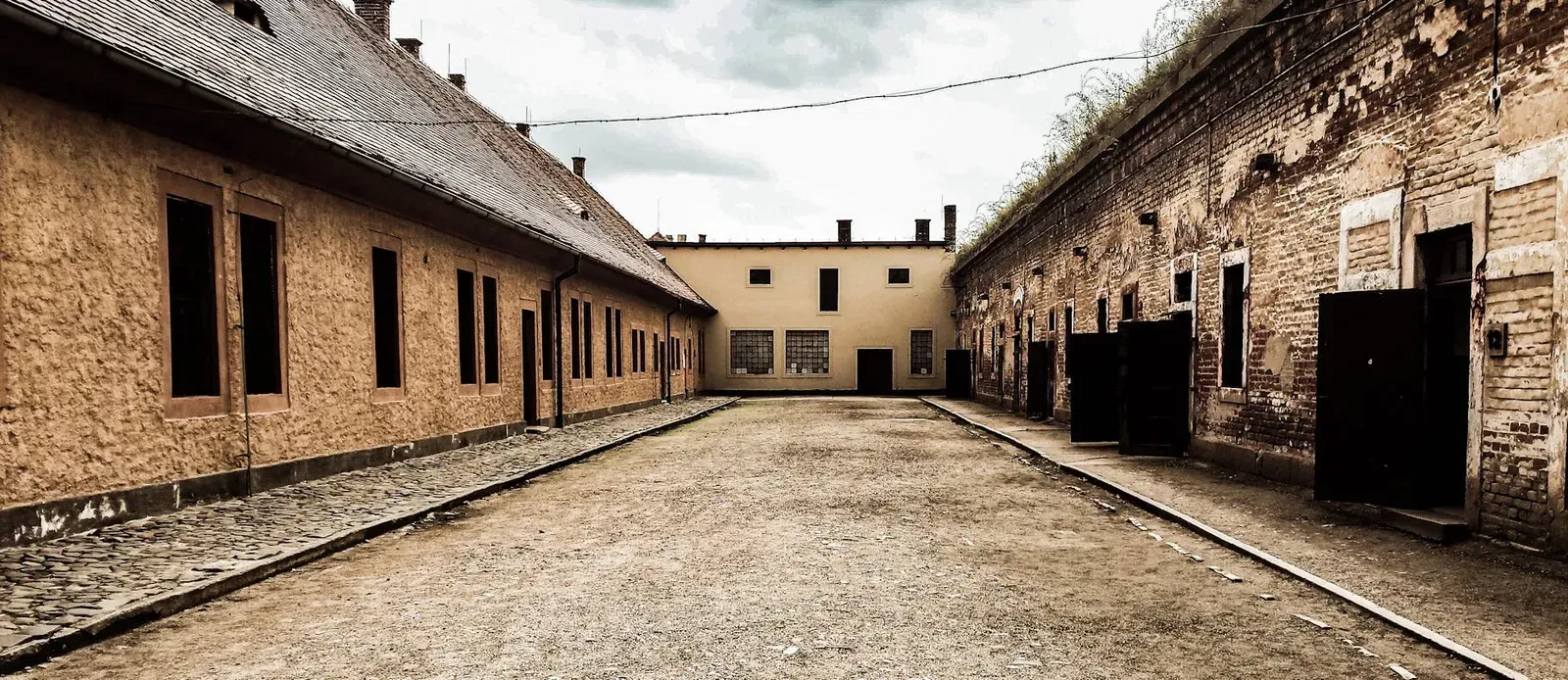 Explore the haunting beauty of a historic abandoned courtyard in Terezín, Czechia.