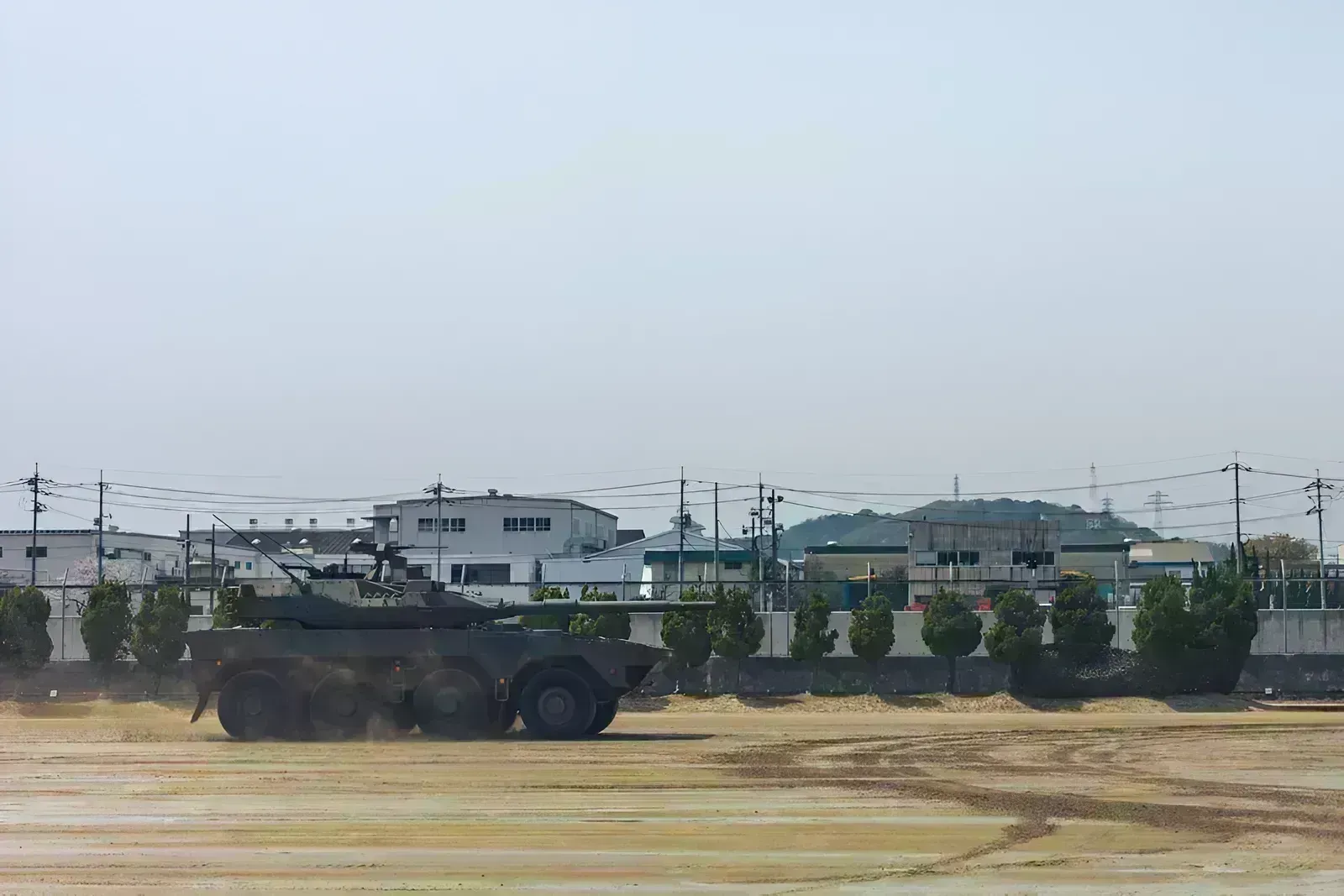 Armored vehicle driving on dusty ground